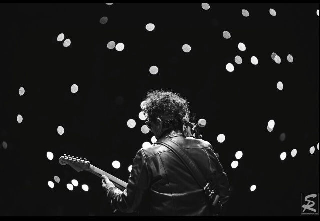 Neal schon plays guitar with a twinkling lights theme