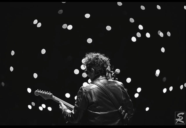 Neal schon plays guitar with a twinkling lights theme